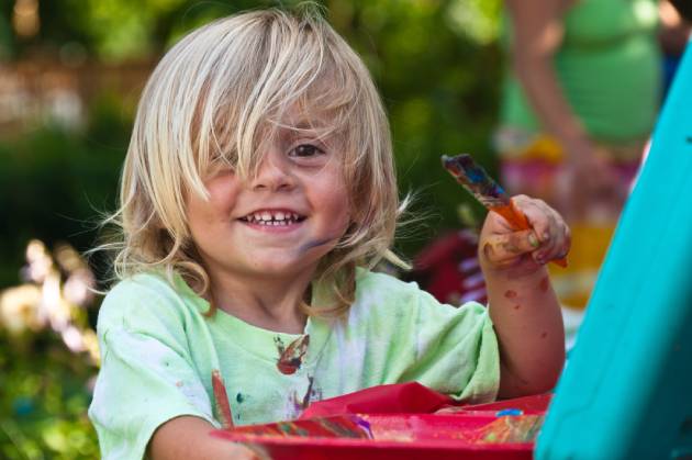 kid painting with large brush