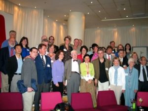 Large group of people standing in several rows at a conference.