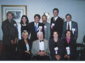 Group of people in formal attire at a conference.