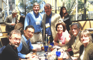 Large group of people seated and standing posing for a conference photo.