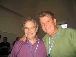 Two conference attendees smiling and posing for a photo.