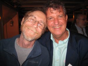 Two men smiling in a photo at a conference.