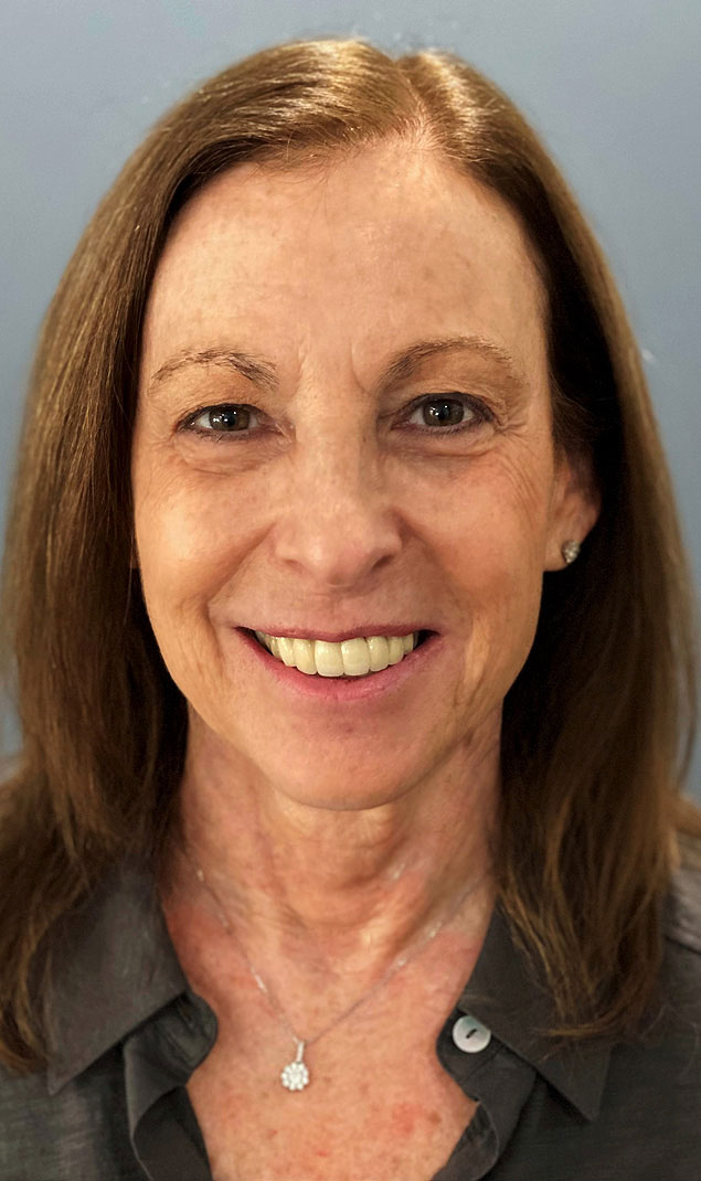 Close-up image of female staff member in full suit